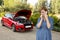 Desperate confused woman stranded with broken car engine crash accident calling on mobile phone