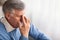 Desperate Elderly Man Thinking Sitting On Couch At Home