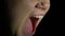 Desperate female shouting black background, hysterical woman screaming, stress