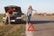 Desperate female stops vehicles on road as needs help, travel together with husband by car and have damage with engine, can`t solv