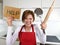 Desperate inexperienced home cook woman crying in stress desperate holding rolling pin and help sign