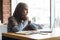 Desperate muslim woman with laptop looking through the window