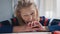 Desperate old woman pensioner looking at small amount of coins on the table