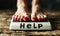 Desperate plea for help on weight scale display under feet with red nail polish, symbolizing weight management struggles and