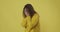 Desperate woman crying over yellow background