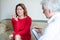 Desperate woman at a psychotherapy session. Male psychotherapist talking to a female patient with depression and