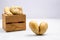 Despicable potatoes of different shapes in a wooden box on a gray background, copy space