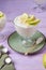 Dessert, airy apple mousse garnished with almond and apple slices, in a transparent bowl on a purple wooden background. Desserts