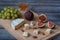 Dessert appetizers to wine - figs, brie cheese, green grapes, honey served on a wooden board
