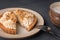 Dessert basket with salted caramel cut and lies on a plate next to a fork for dessert and cappuccino