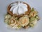 Dessert Cake with white cream in a basket of dough Blooming yellow roses Saucer on a wooden table Close-up