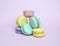 Dessert cakes of different colors, French sweet buns on a purple background, for confectioners, for shops, for congratulations,
