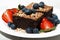 Dessert - chocolate brownies with fresh berries on plate