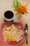 Dessert. Crackled crispy cookies with sugar on a plate and a cup of coffee on a wooden table.