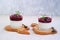 Dessert, creamy panna cotta with cherry sauce in glass glasses on a light concrete background