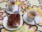 Dessert food composition: two coffee cups, tiramisu sweet chocolate cake