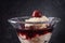 Dessert glass with semolina pudding, cherries and fruit sauce on