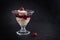 Dessert glass with semolina pudding, cherries and fruit sauce on