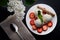 Dessert, ice cream with waffle, strawberry and mint slice, white plate, black background, top view