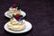 Dessert Madame Pavlova with fresh raspberries and blueberries, decorated with mint and cornflower flowers. Light dessert with