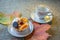 Dessert with orange and marmalade on the background of autumn leaves.