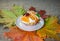 Dessert with orange and marmalade on the background of autumn leaves.