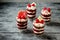 Dessert  portioned in glasses.  Red biscuit with raspberry jelly, cream and fresh raspberries