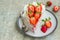 Dessert, sliced sponge cake with custard, fresh strawberries and whipped cream on a gray concrete background. Swedish cuisine