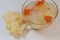 Dessert soup of double boiled snow or white fungus with papaya in glass bowl with dried Tremella fuciformis, on white