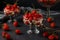 Dessert with strawberries, cottage cheese and biscuit in glass goblets against a dark background