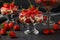 Dessert with strawberries, cottage cheese and biscuit in glass goblets against a dark background