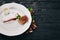 Dessert. Strudel with berry jam and ice cream on a plate. On a wooden background.