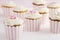 Dessert table of pink and white retro style cupcakes