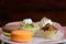 Dessert tartlet with magaron and kiwi fruit mixed on plate