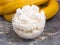 Dessert: whipped cream with banana in a cream bowl on a gray background
