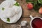 Dessert zephyr marshmallow on a white plate, a cup of tea and fruits on the table, top view, afternoon tea in the garden. Airy