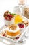 Desserts with pumpkin, berries and biscuits, vertical