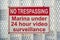 Destin, Florida- No Trespassing, Marina under 24 hour video surveillance sign