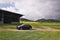 Destna, Czech republic - April 26, 2018: black car Opel Astra H stand on field road leading to abandoned farmhouse before spring r