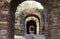 Destroyed brick arch old brickwork corridor long dark corridor under