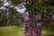 Destroyed a brick chimney on a background of greenery