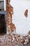 Destroyed building with a damaged wall and a pile of broken brick