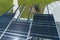 Destroyed by hurricane wind photovoltaic solar panels mounted on carport roof for producing green ecological electricity