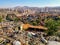 Destroyed huts of the slums of Ankara on the background of a panorama of a city landscape with mountains on the horizon. Contrast