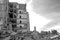 Destroyed large building with a blockage of concrete debris in the foreground. Background