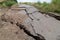 Destroyed road consequences of a natural cataclysm of a landslide.