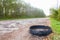 Destroyed rubber car tire car on rural bumpy broken road.