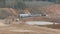 Destroyed train among the sand ballast quarry on the cloudy summer day