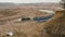 Destroyed train among the sand ballast quarry on the cloudy summer day