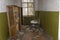 Destroyed wooden furniture and rusty kid bed inside abandonated room at chernobyl